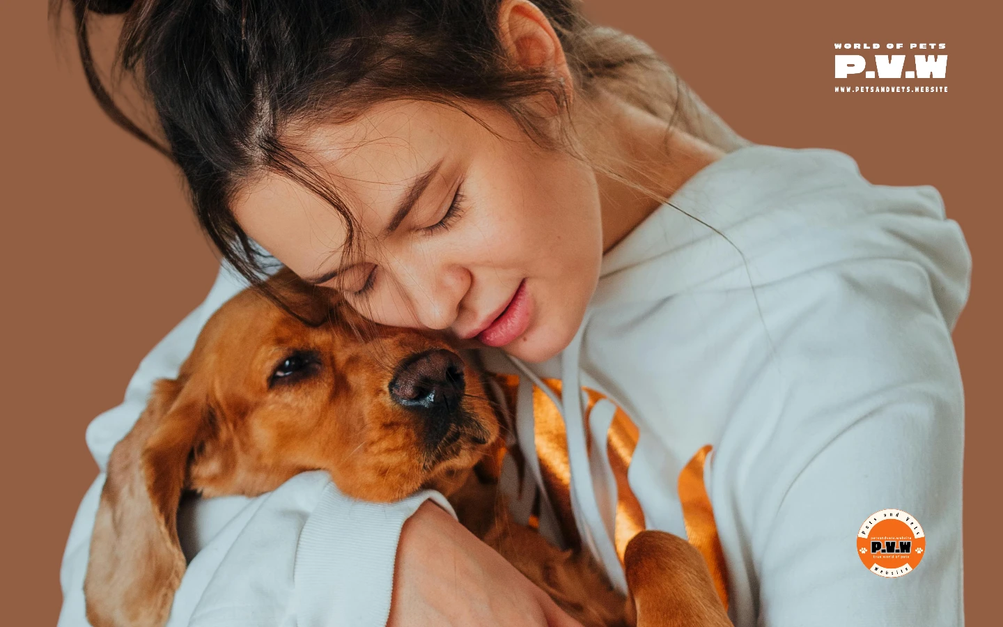 A young girl hugging and showering love on a happy dog.